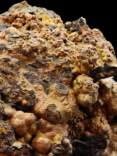 Detail of iridescent goethite surface with green and gold sheen, Su Zurfuru Mine