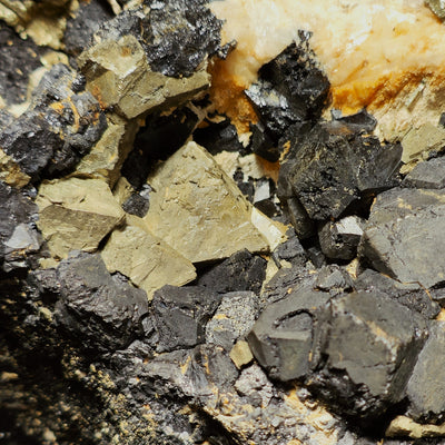 Detail of Pyrite and Magnetite crystals beside white quartz matrix