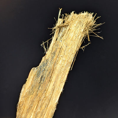 Angled view of Balangeroite fibrous crystals showing natural golden sheen, Balangero, Italy
