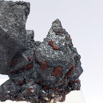 Close-up of pyramidal Martite crystal with reddish iddingsite spots on matrix