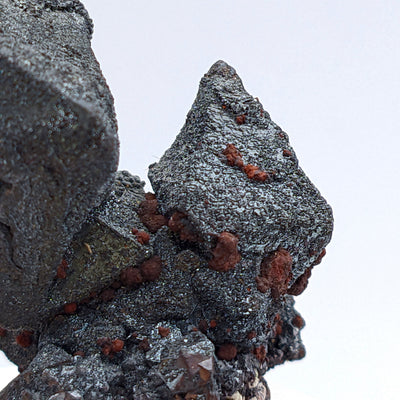 Macro detail of hematite octahedron surface with reddish mineral crusts, Argentina