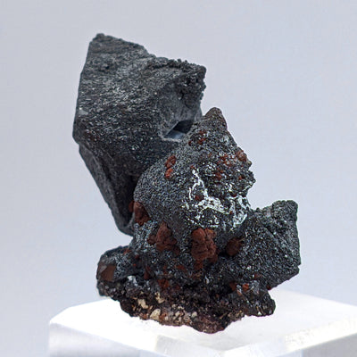 Hematite after Magnetite specimen on acrylic stand showing twin octahedral crystals