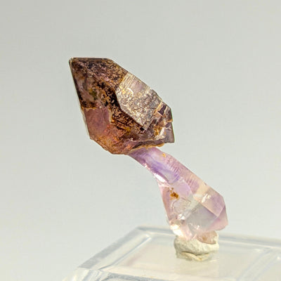 Side view of amethyst scepter showing pale lilac stem and purple crystal head