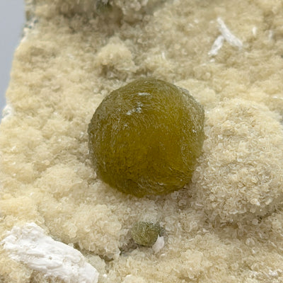 Detail of Gyrolite sphere with fine white Okenite tufts on matrix, Pune, India