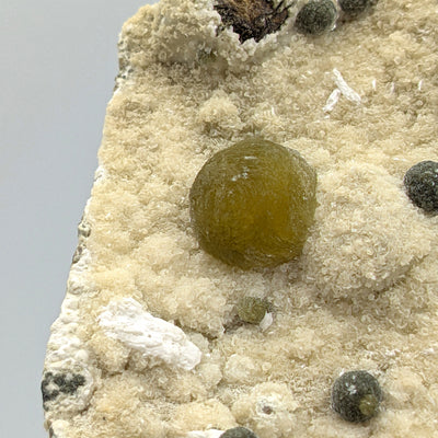 Gyrolite sphere with Okenite tufts and dark satellite balls, Pune, India