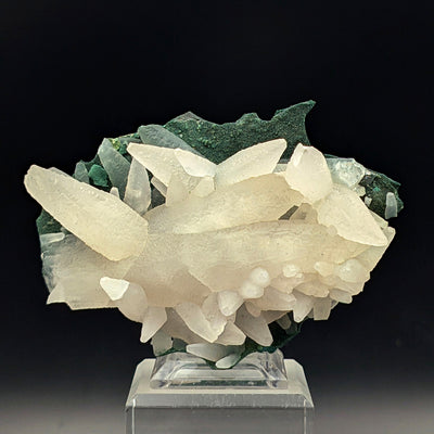 Front view of white Calcite crystal cluster on copper-oxide matrix stand