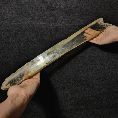 Two hands supporting the full length of the giant Gypsum sword crystal, San Lazzaro di Savena