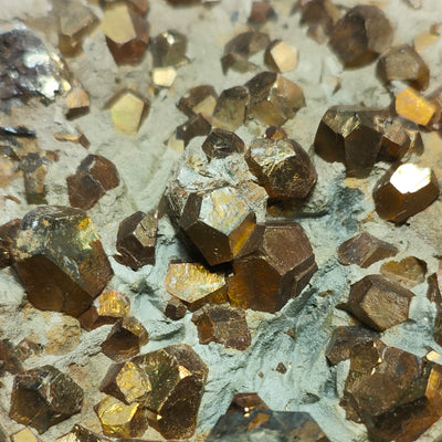 Pyrite crystal cluster with bronze and gold iridescence from iron oxide coating
