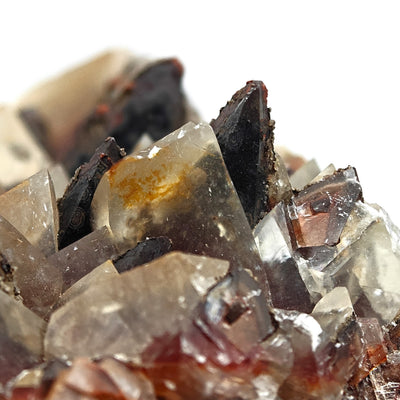 Close-up of transparent calcite scalenohedra with orange mineral inclusions, Santa Eulalia, Mexico