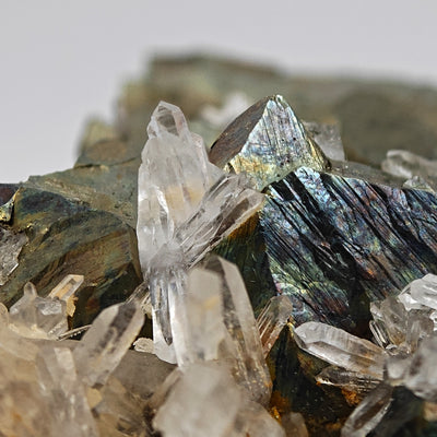 Close-up of a single quartz crystal point beside an arsenopyrite crystal face