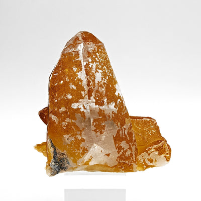 Side view of orange quartz crystal with limonite coating and smaller crystal matrix