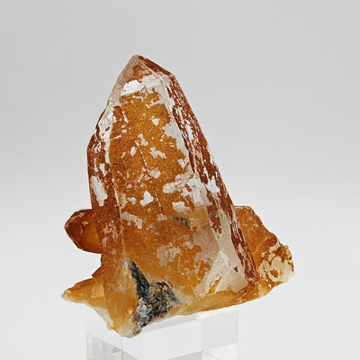 Front view of quartz crystal cluster with vivid orange limonite inclusions, Disentis