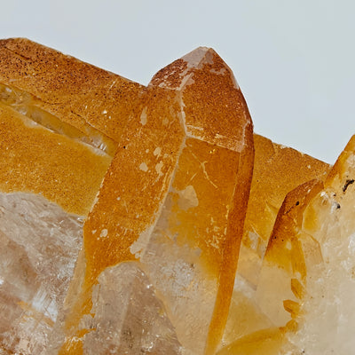 Detail of parallel quartz crystals with orange limonite staining on crystal faces
