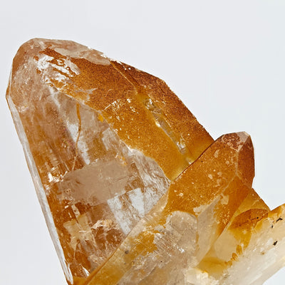 Close-up of quartz crystal edge showing limonite coating and internal fractures