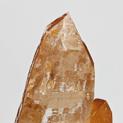 Detail of quartz crystal termination with light orange limonite dusting, Disentis
