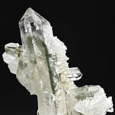 Top view of quartz crystal point with green chlorite phantom and satellite crystals