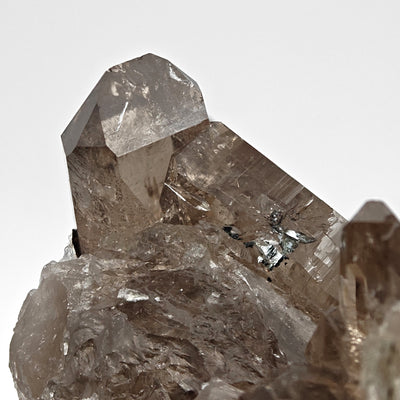 Detail of smoky quartz crystal faces with small hematite inclusion, Cavradi Gorge