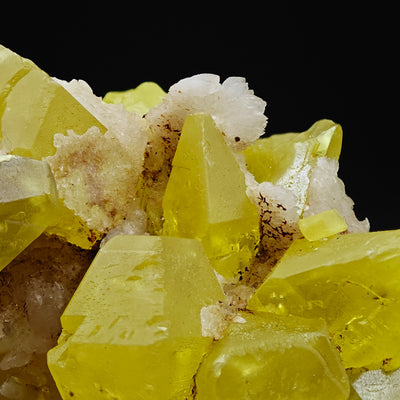 Pyramidal Sulfur crystal among Aragonite sprays, Cozzo Disi Mine, Sicily, Italy
