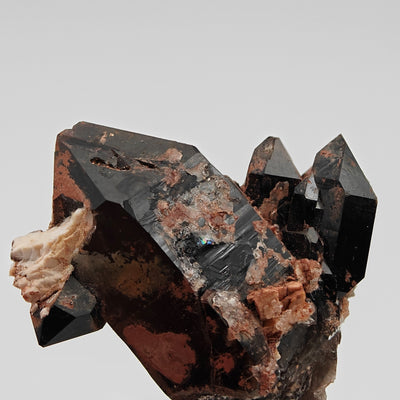 Close-up of black morion quartz crystal faces and hematite inclusions