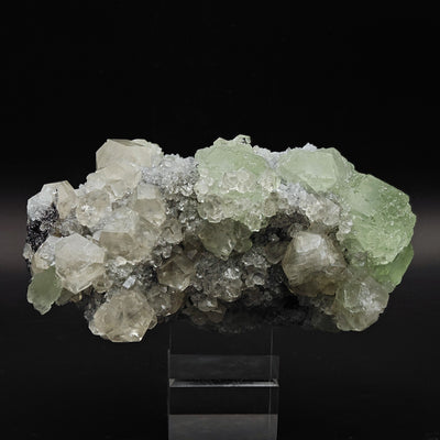 Full specimen view showing green Fluorite and Calcite crystals on Quartz matrix, mounted on stand