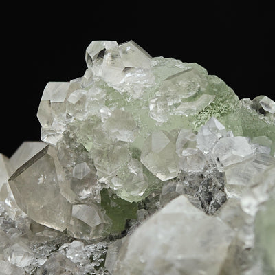 Close-up of Calcite crystal terminations with green Fluorite in the background