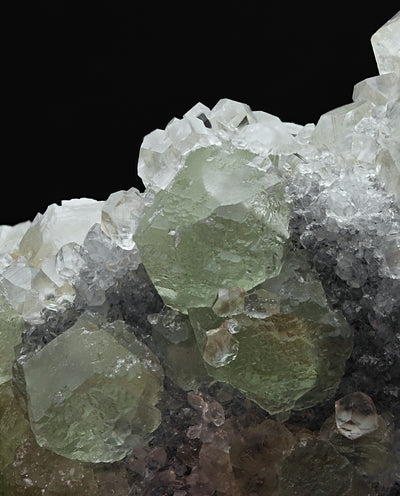 Detail of lustrous green Fluorite crystals with Calcite and Quartz matrix