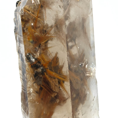 Close-up of rutile needle sprays on hematite matrix inside transparent smoky quartz
