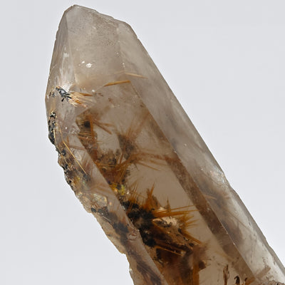 Top view of smoky quartz point with hematite and rutile star inclusions, Brazil