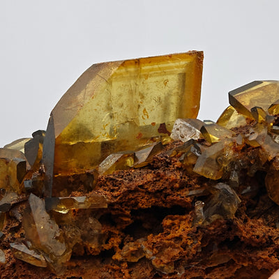 Baryte crystal cluster detail showing tabular crystals on reddish matrix, Sardinia