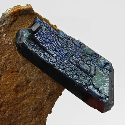 Vivianite crystal on matrix displaying deep blue-green coloration, Bolivia