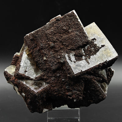 Fluorite specimen on stand under studio lighting showing crossed crystal habit