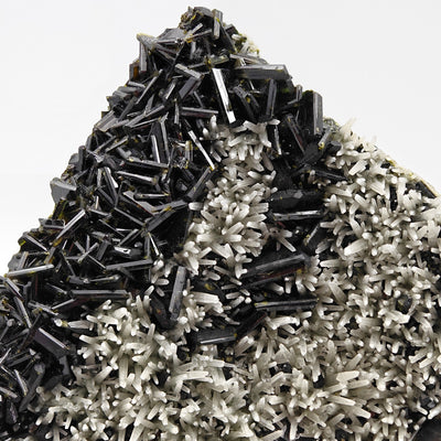 Angled view of epidote crystal cluster rising above quartz matrix, Iran