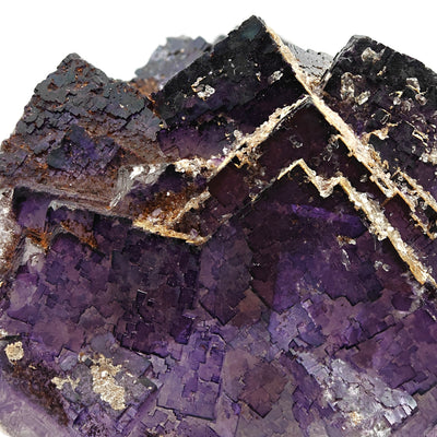 Close-up of fluorite cubic crystal faces with iron oxide staining