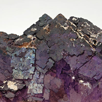 Detail of fluorite cubic crystals showing iridescent dark faces