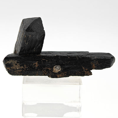 Full view of ilvaite specimen with two crossed crystals on acrylic stand