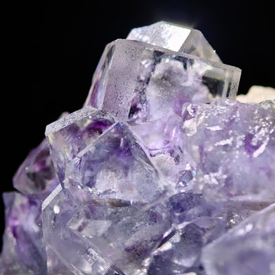 Close-up of layered fluorite crystals with internal purple inclusions