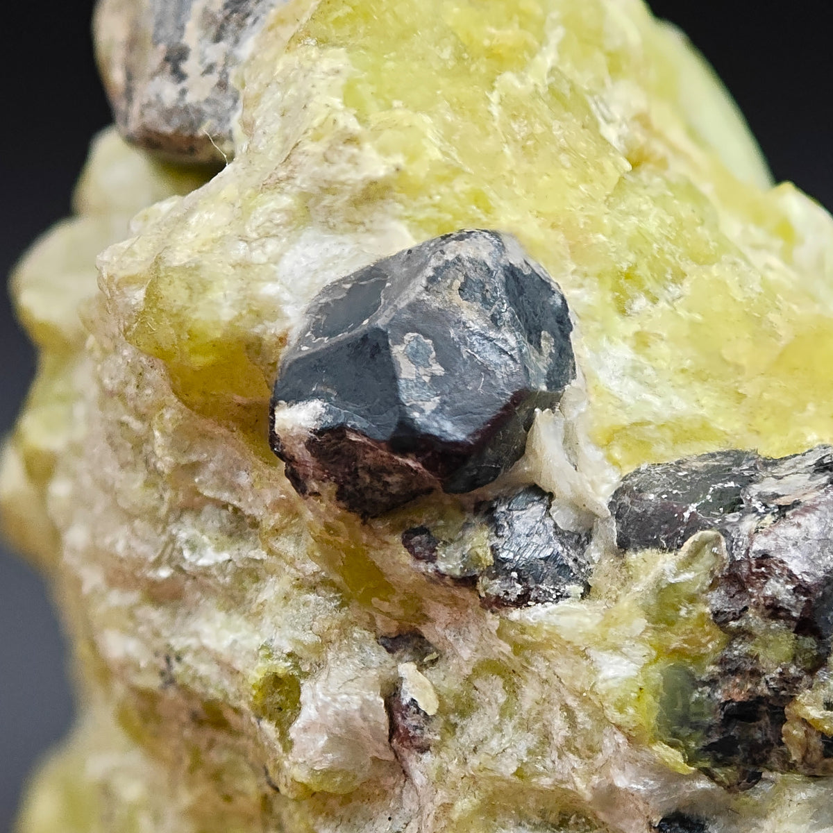 Martite crystal with reddish edges on yellow Lizardite matrix, Snarum, Norway