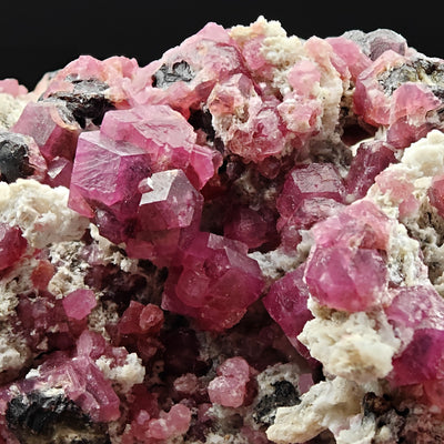 Detail of a Rosolite Garnet crystal cluster showing dodecahedral faces, Mexico