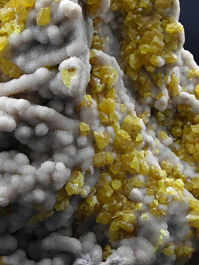 Sulfur crystal clusters among ridged Aragonite formations, Cozzo Disi Mine, Sicily