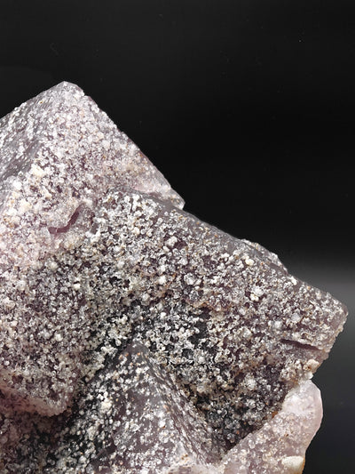 Close-up of Fluorite crystal surface with sparkling quartz coating