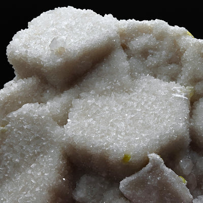 Close-up of pseudo-hexagonal aragonite twins with small sulfur inclusions on matrix