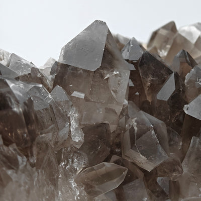 Close-up of smoky quartz crystal cluster showing crystal clarity