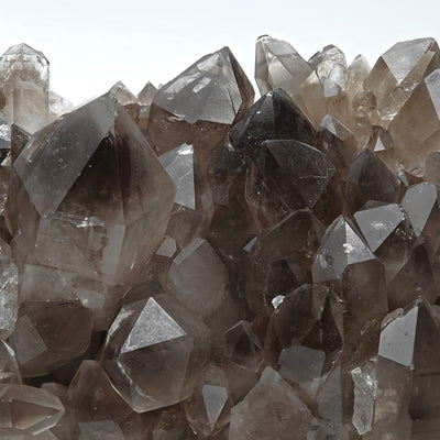 Close-up of smoky quartz crystal terminations and matrix base