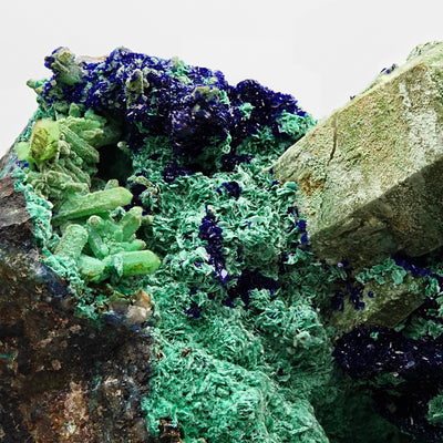 Malachite stalactitic growth beside azurite crystals and quartz on matrix