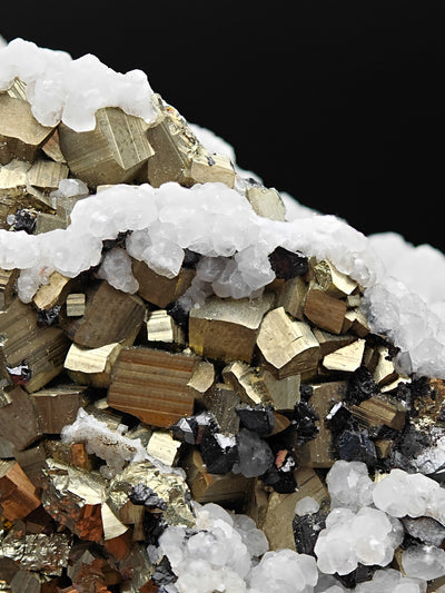 Macro view of pyrite cubes and sphalerite crystals beneath calcite rim, Huanzala Mine