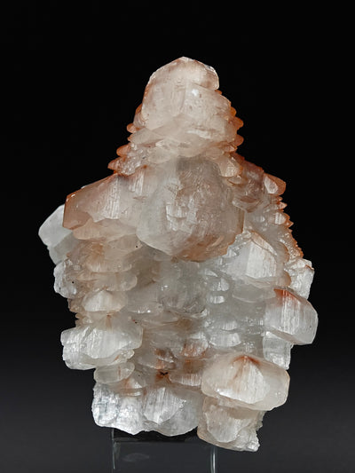 Pagoda-style calcite cluster with translucent crystal faces and hematite streaks, Hubei
