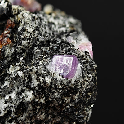 Detail of a single violet Sapphire crystal face on matrix