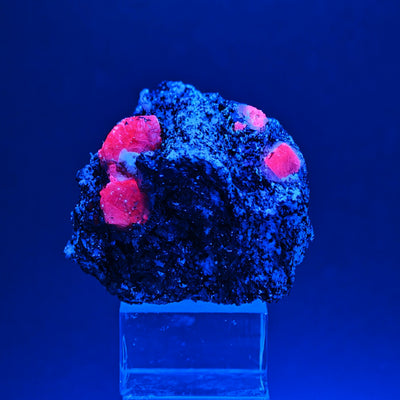 Sapphire crystals fluorescing red under UV light, Zazafotsy, Madagascar