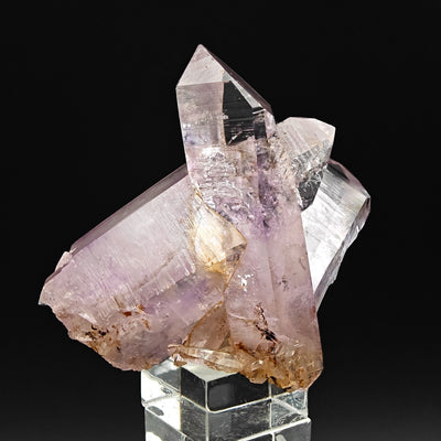 Translucent amethyst crystals with iron oxide staining on matrix