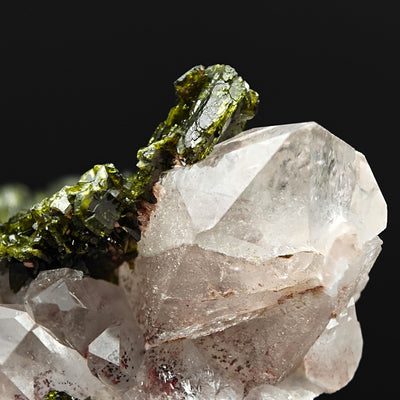 Close-up of epidote blades perched on amethystine quartz crystal face